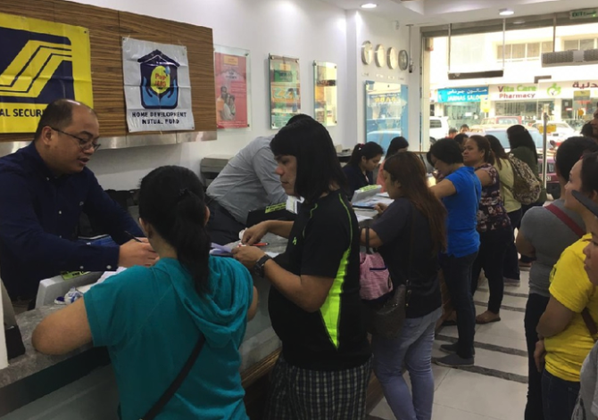 filipinos in a bank remitting money